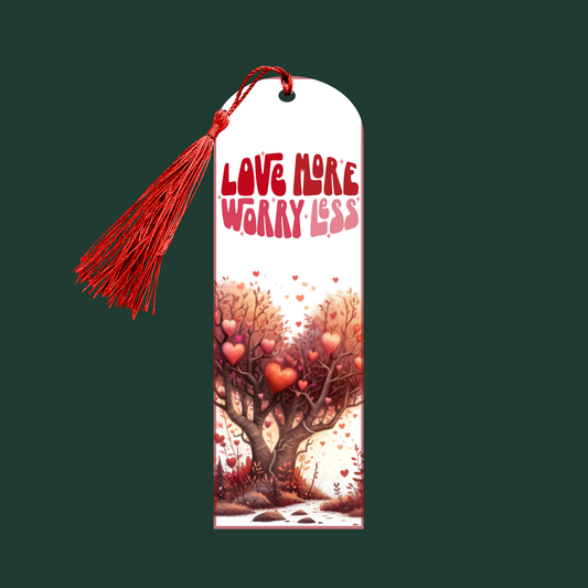 "Aluminum bookmark with the phrase ‘Love More, Worry Less,’ heart-shaped trees, floating hearts, and a red tassel."
