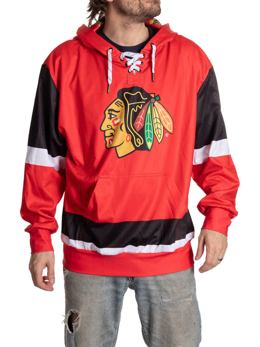 Person wearing a red and black hoodie with a sports team logo on a white background