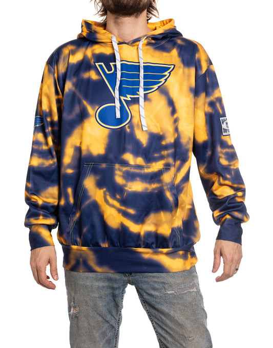Person wearing a blue and yellow tie-dye hoodie with a logo on a white background
