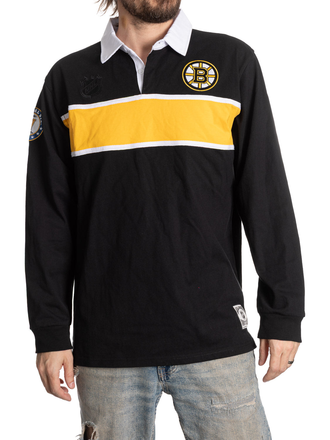 Black rugby shirt with yellow stripe and logo on a white background