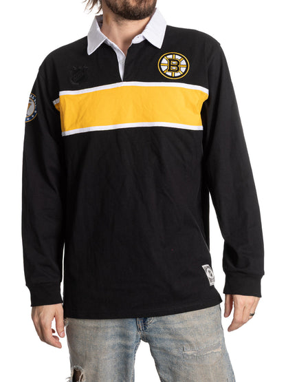 Black rugby shirt with yellow stripe and logo on a white background