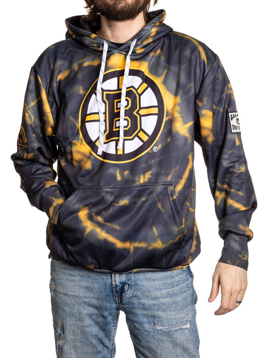 Person wearing a tie-dye hoodie with a sports team logo on a white background