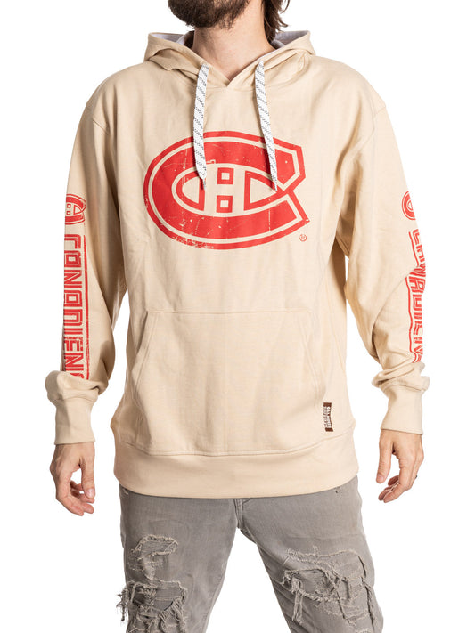 Beige hoodie with red logo worn by a person on a white background