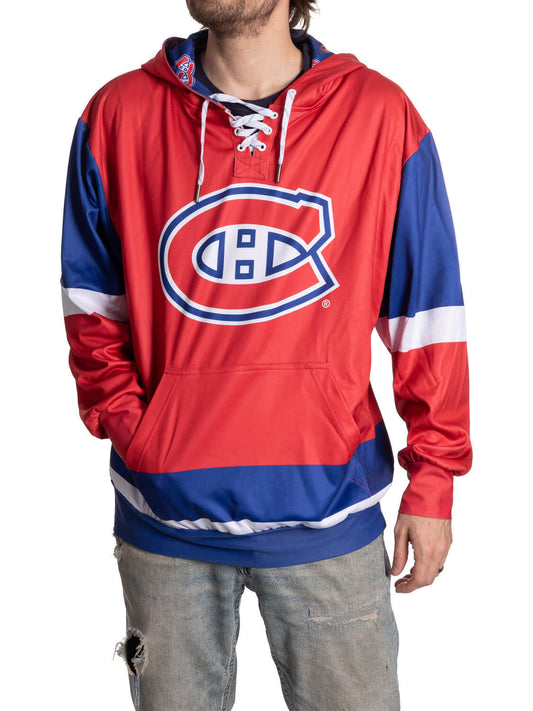 Person wearing a red and blue hoodie with a logo on a white background