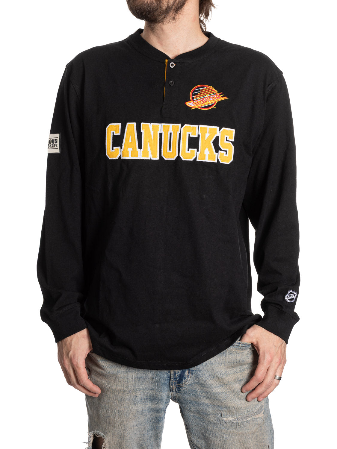 Black long-sleeve shirt with 'Canucks' text and logo on a white background
