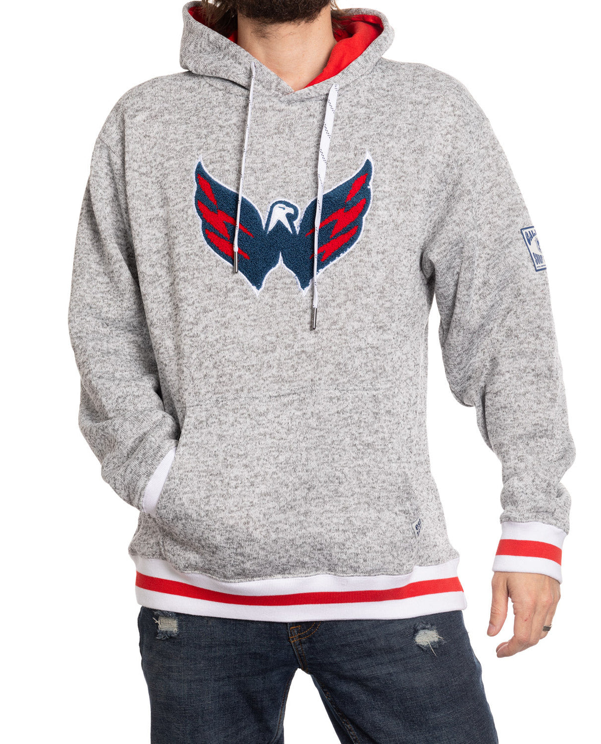 Person wearing a gray hoodie with a logo on a white background
