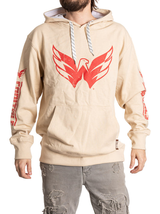 Beige hoodie with red eagle logo worn by a person on a white background