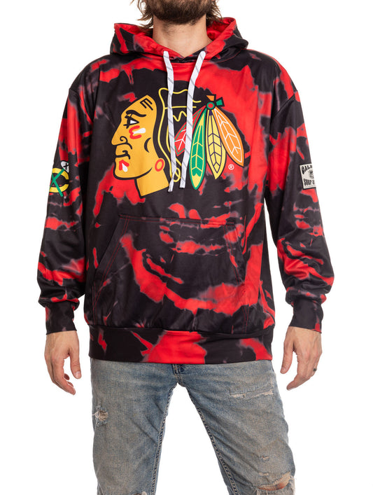 Person wearing a Chicago Blackhawks hoodie with a red and black design.