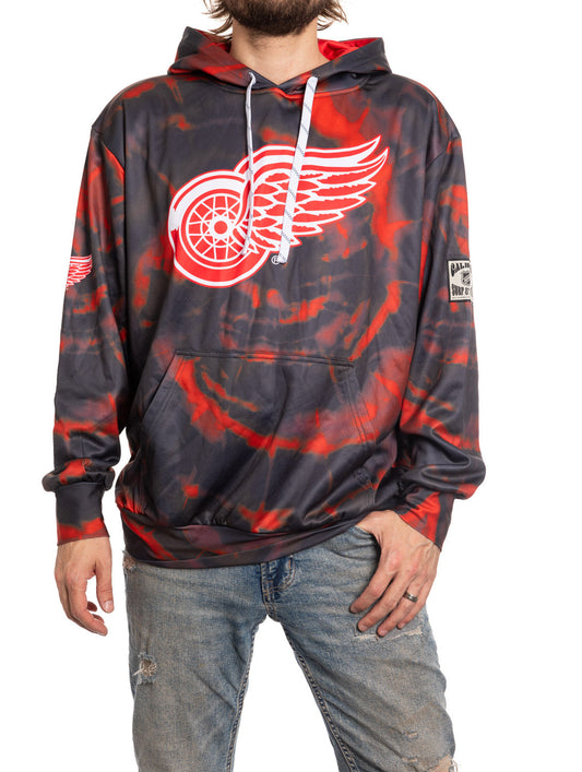 Person wearing a tie-dye hoodie with a red and black design and logo on a white background