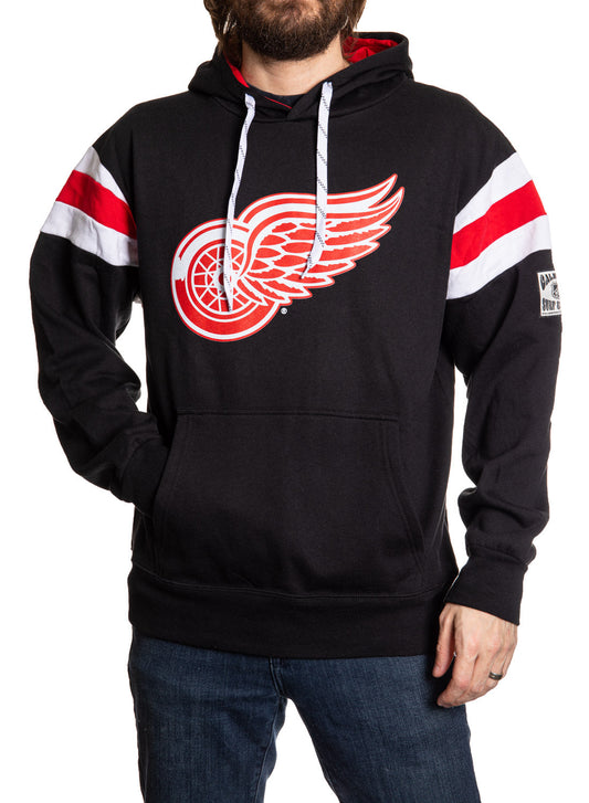 Black hoodie with a red and white logo worn by a person on a white background