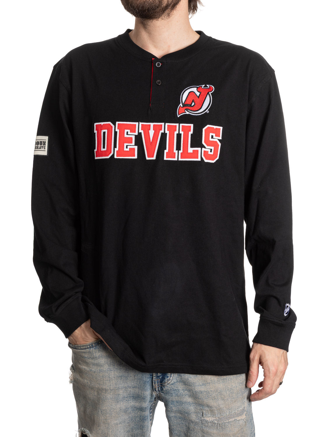 Black long-sleeve shirt with 'DEVILS' text and logo worn by a person on a white background