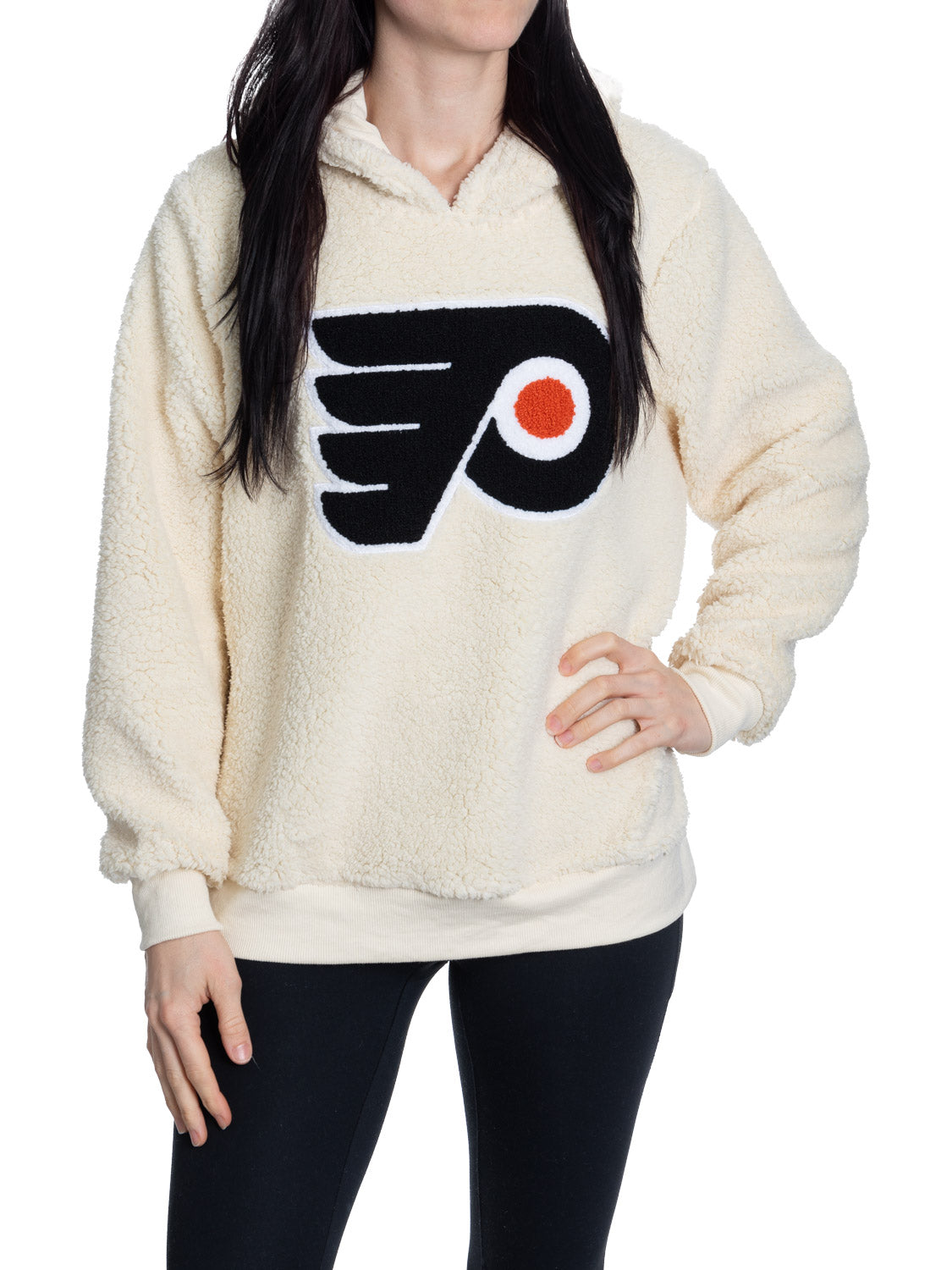 Person wearing a cream sherpa-lined hoodie with a sports team logo on a white background