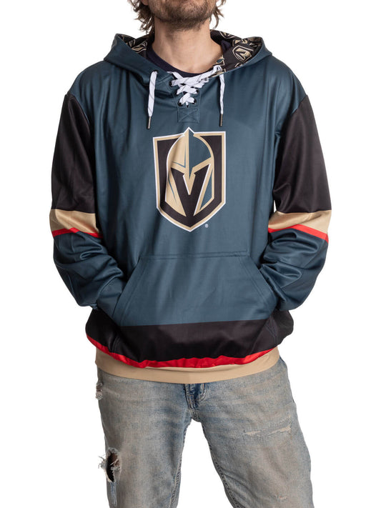 Person wearing a teal hoodie with a logo on a white background