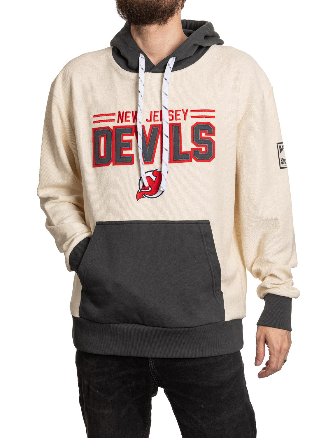 Person wearing a New Jersey Devils hoodie on a white background
