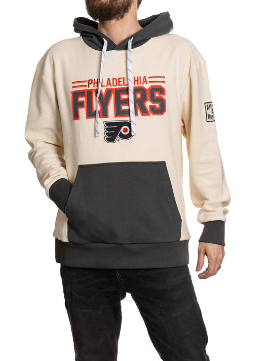 Person wearing a Philadelphia Flyers hoodie on a white background
