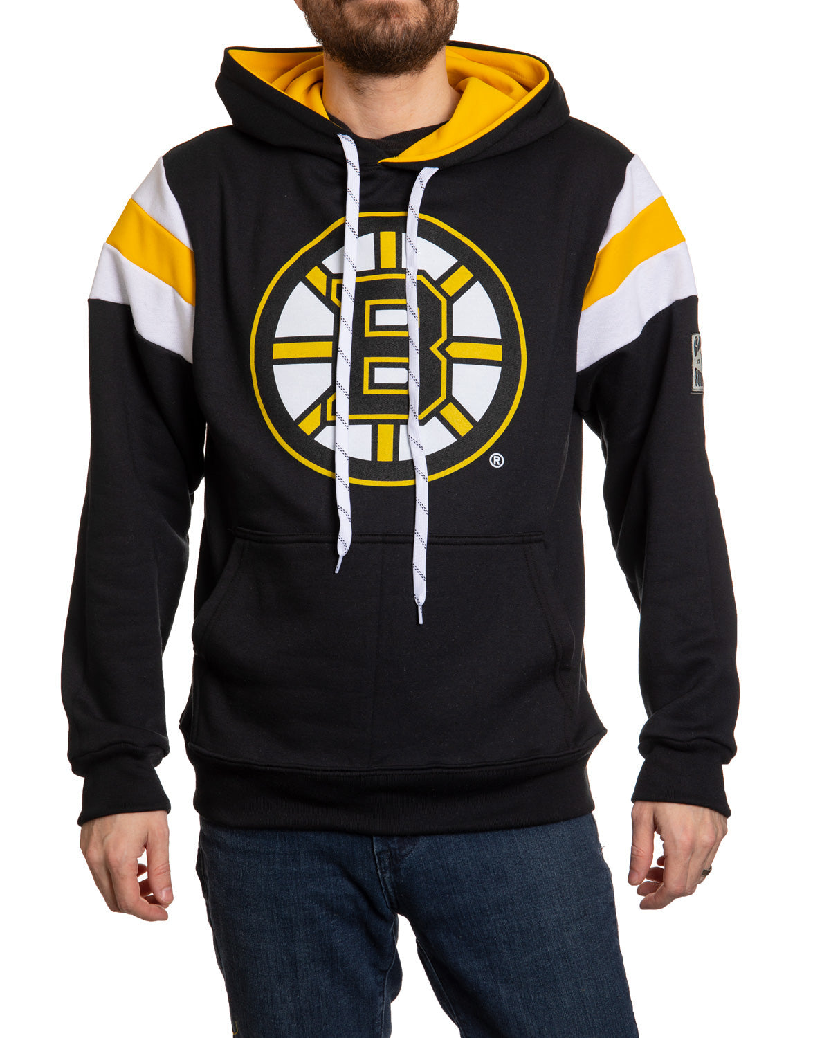 Black hoodie with yellow and white accents featuring a logo, worn by a person on a white background