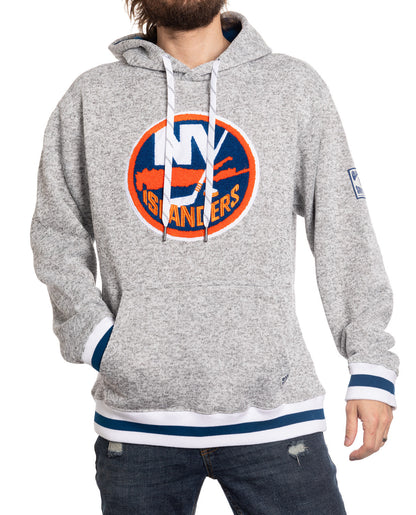 Gray hoodie with Islanders logo worn by a person on a white background