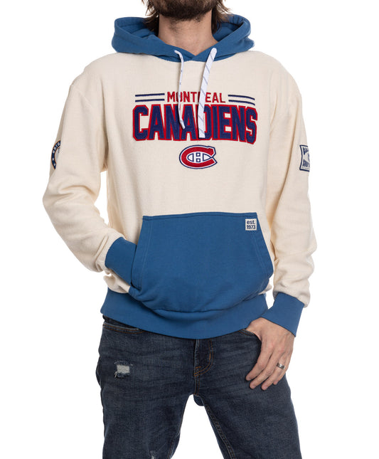Person wearing a Montreal Canadiens hoodie with blue and white design