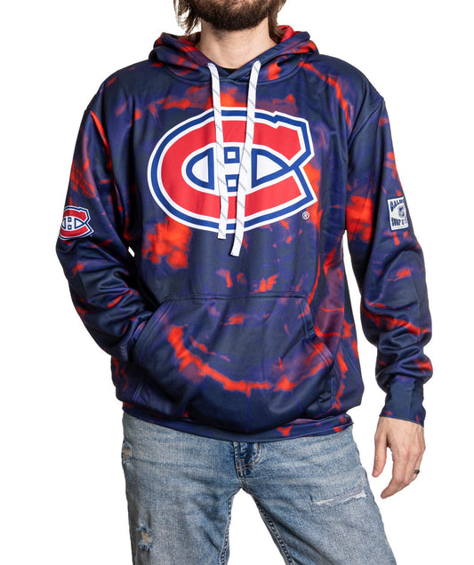Person wearing a blue and red tie-dye hoodie with a sports team logo on a white background