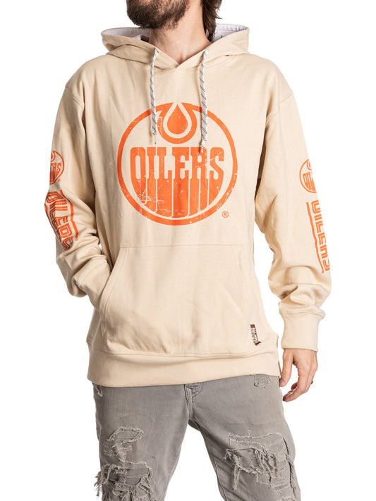 Beige hoodie with orange 'Oilers' logo worn by a person on a white background