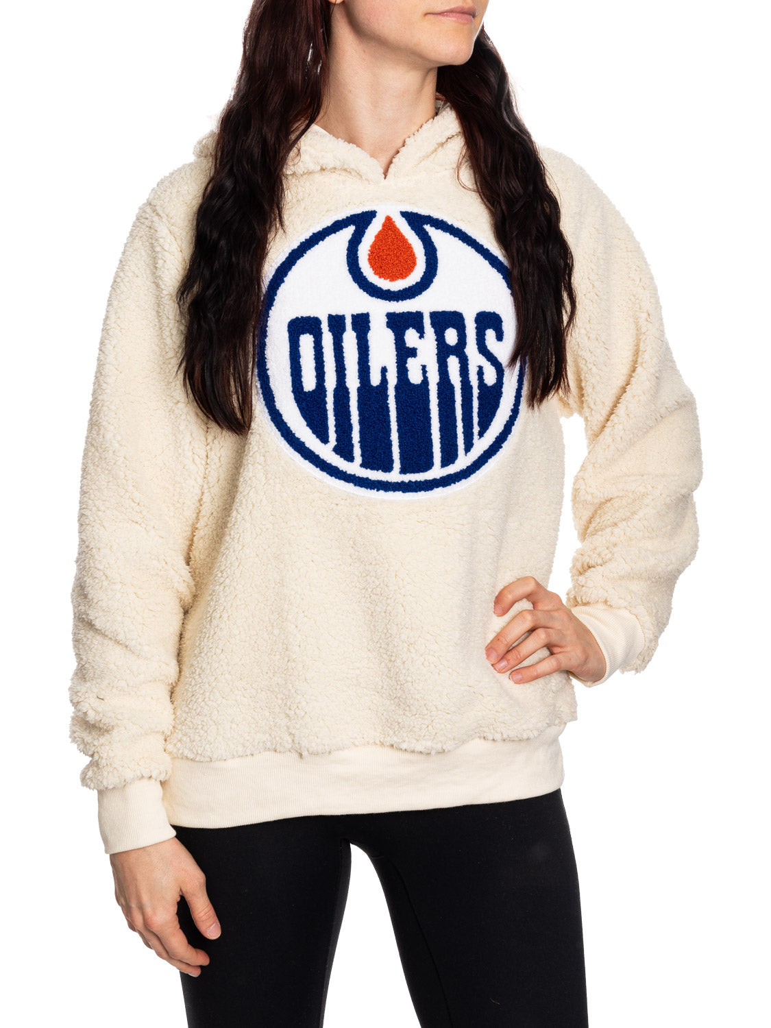 Person wearing a cream-colored hoodie with Oilers logo on a white background