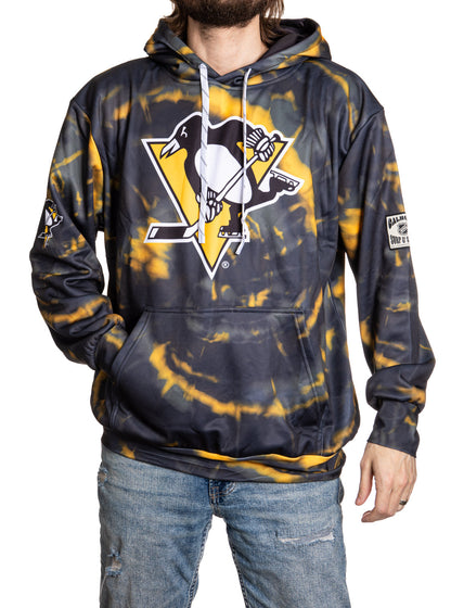 Person wearing a tie-dye hoodie with a logo on a white background
