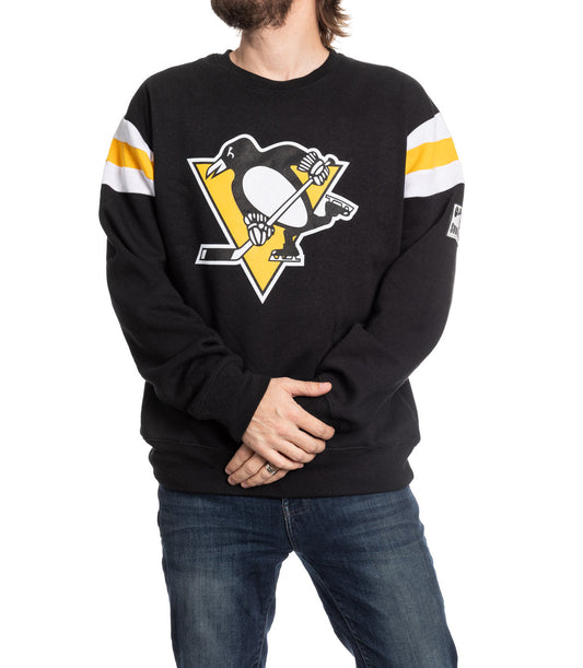 Person wearing a black sweater with a sports team logo on a white background