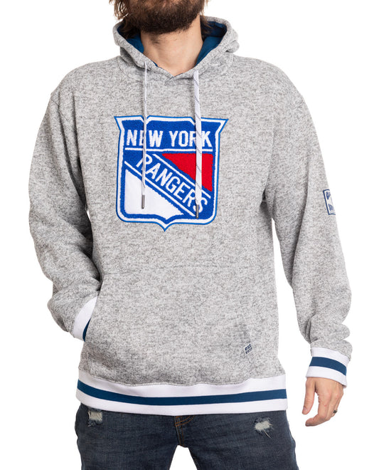 Person wearing a gray hoodie with New York Rangers logo on a white background