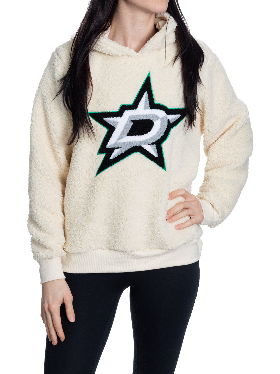 Person wearing a cream sherpa hoodie with a star logo on a white background