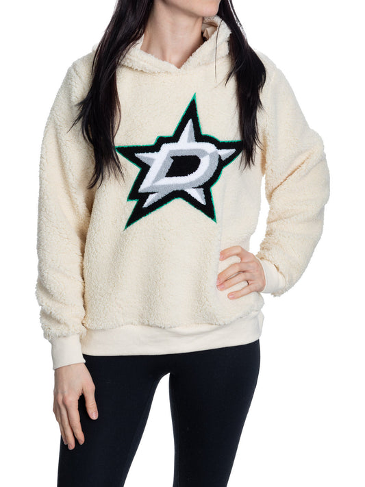 Person wearing a cream sherpa hoodie with a star logo on a white background