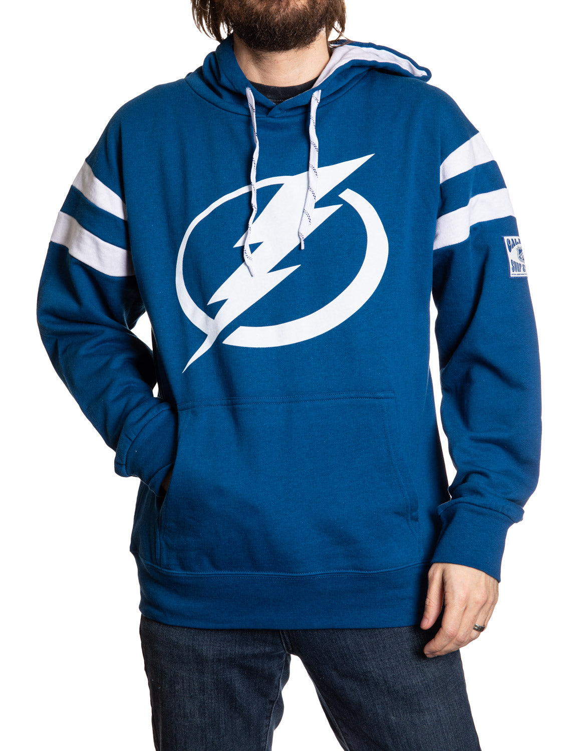Blue hoodie with a white logo worn by a person on a white background