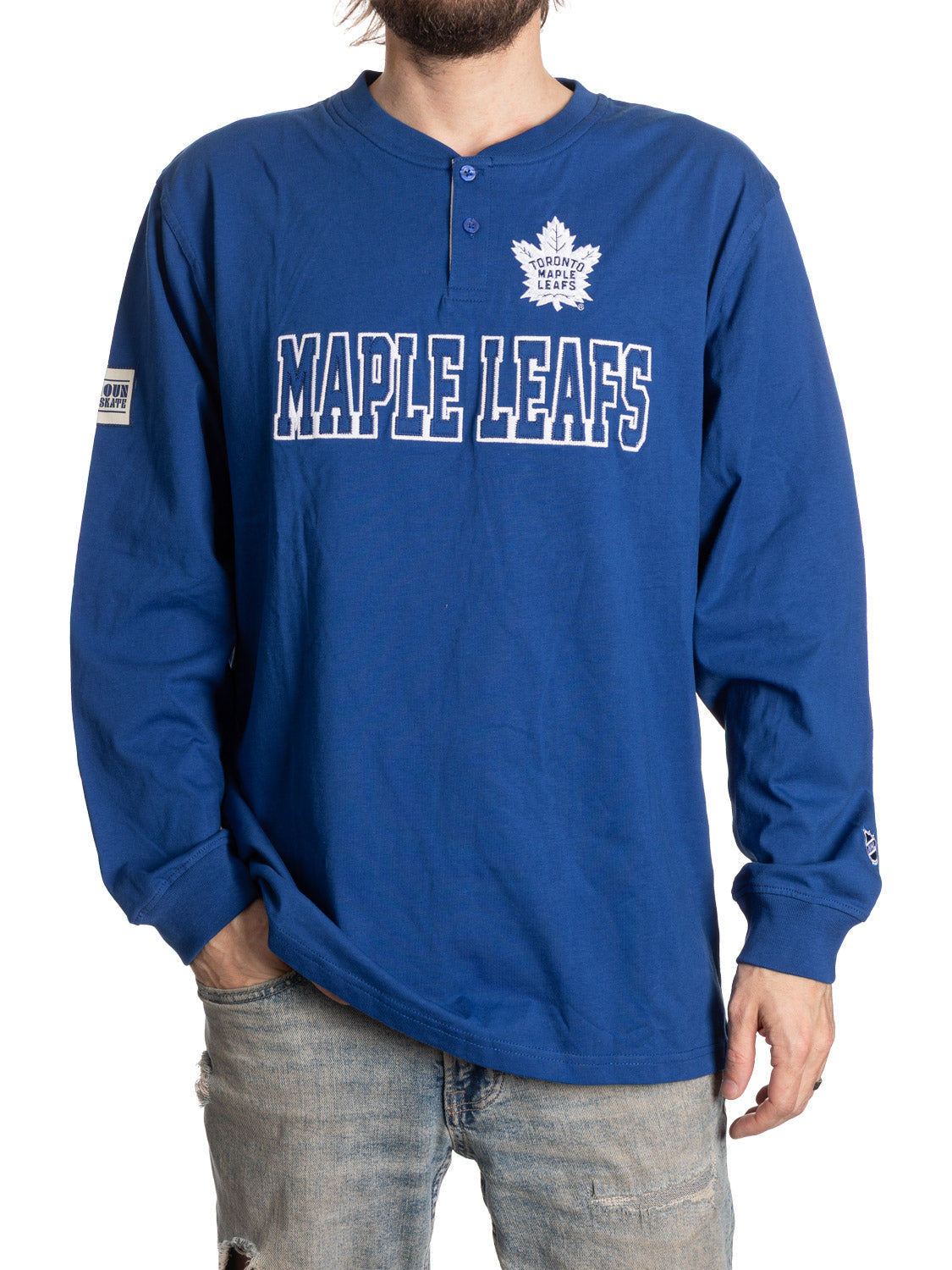 Blue long-sleeve shirt with 'Maple Leafs' text on a white background