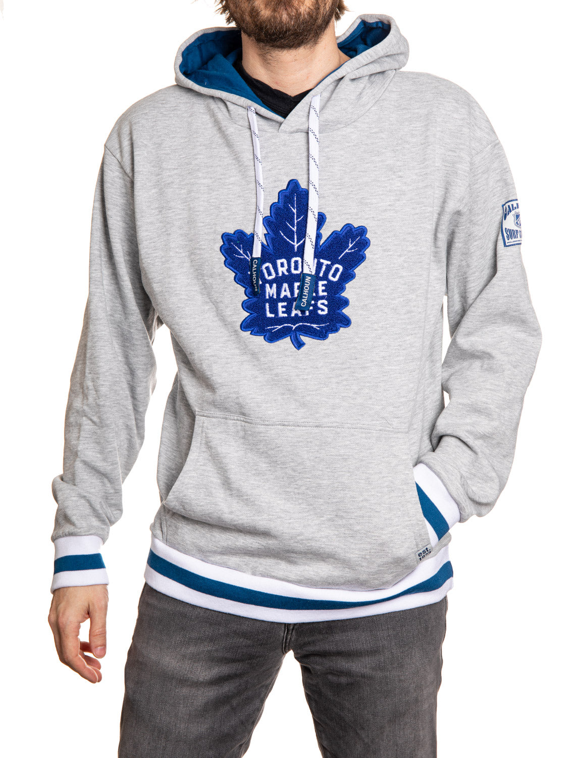 Person wearing a gray hoodie with a blue Toronto Maple Leafs logo on a white background
