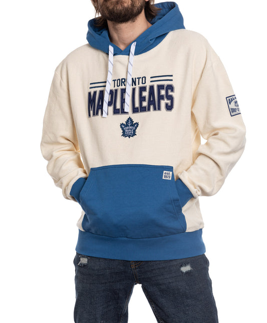 Person wearing a Toronto Maple Leafs hoodie with blue and white design elements.
