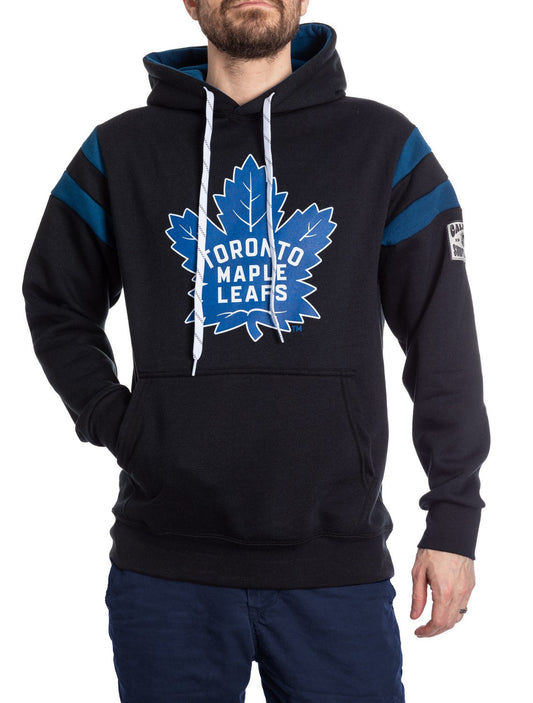 Black hoodie with blue accents and Toronto Maple Leafs logo worn by a person on a white background