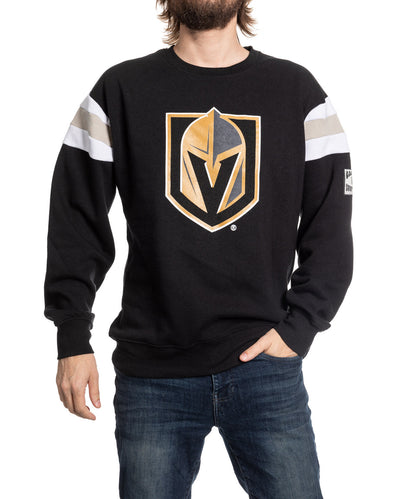 Person wearing a black sweatshirt with a sports team logo on a white background